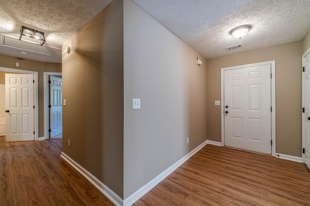 701 Woodland Ridge Drive Monroe, GA 30656 - Photo 5 of 39 a view of a hallway with wooden floor