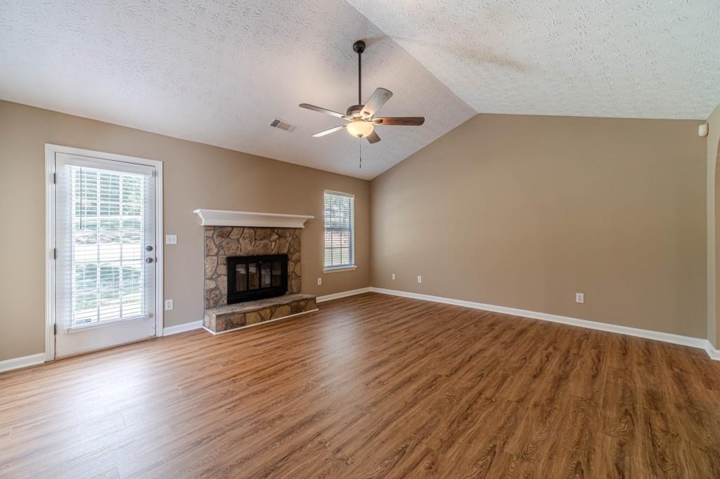 701 Woodland Ridge Drive Monroe, GA 30656 - Photo 8 of 39 wooden floor fireplace and windows in an empty room
