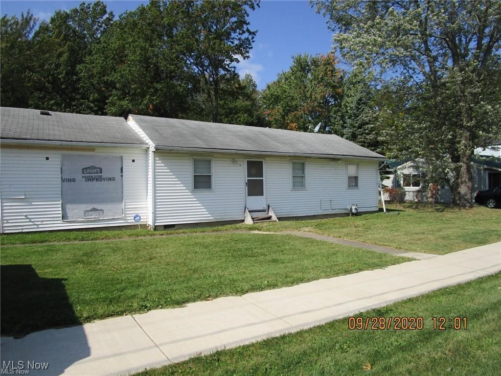 View of front of house with a front yard and entry steps