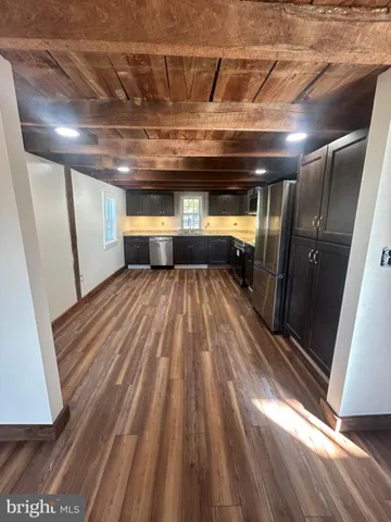 a view of a room with wooden floor