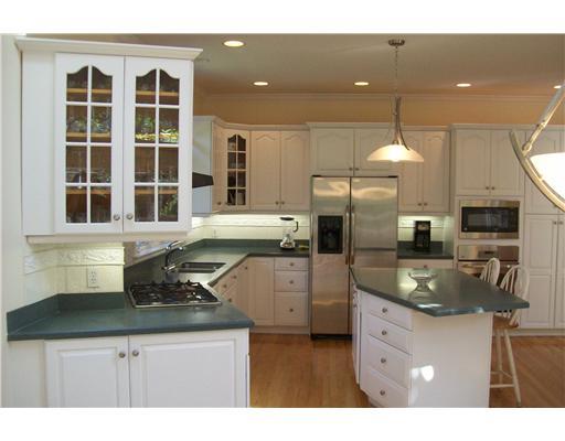 3 Circle Road Darien, CT 06820 - Photo 13 of 20 a kitchen with stainless steel appliances granite countertop a sink a stove and a refrigerator