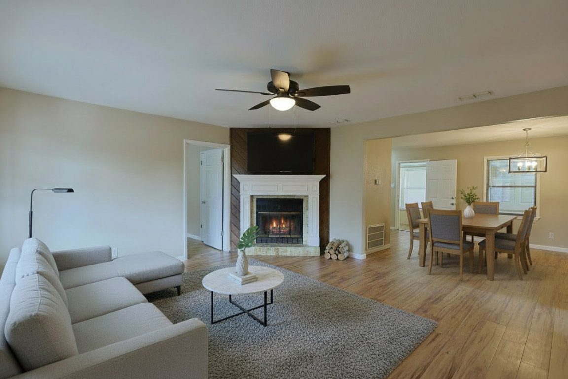 111 Branch View Drive Kyle, TX 78640 - Photo 20 of 27 a living room with furniture a chandelier and a fireplace