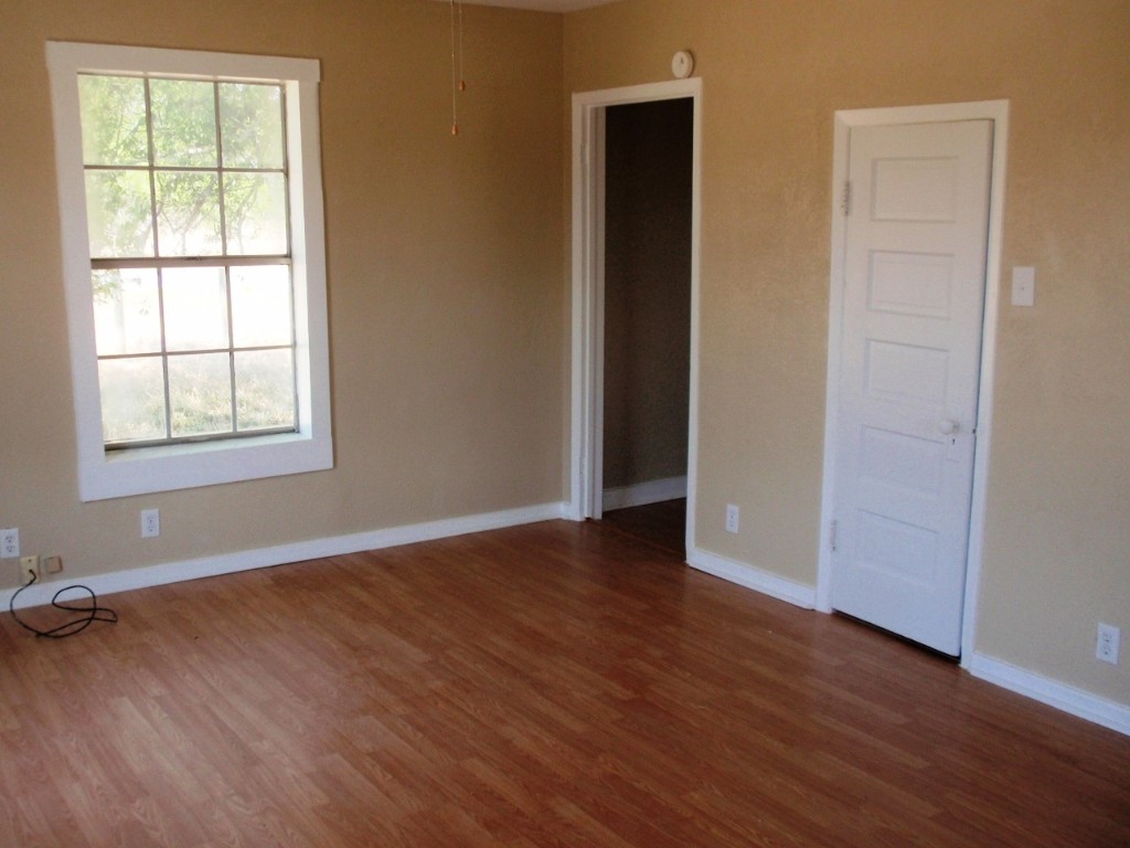111 Branch View Drive Kyle, TX 78640 - Photo 22 of 27 an empty room with wooden floor and windows