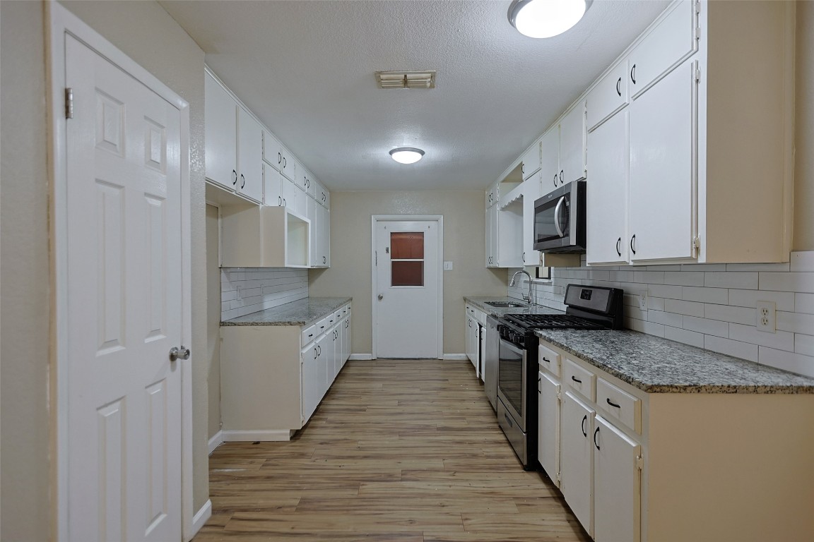 111 Branch View Drive Kyle, TX 78640 - Photo 3 of 27 a large kitchen with stainless steel appliances granite countertop a stove a sink and a refrigerator