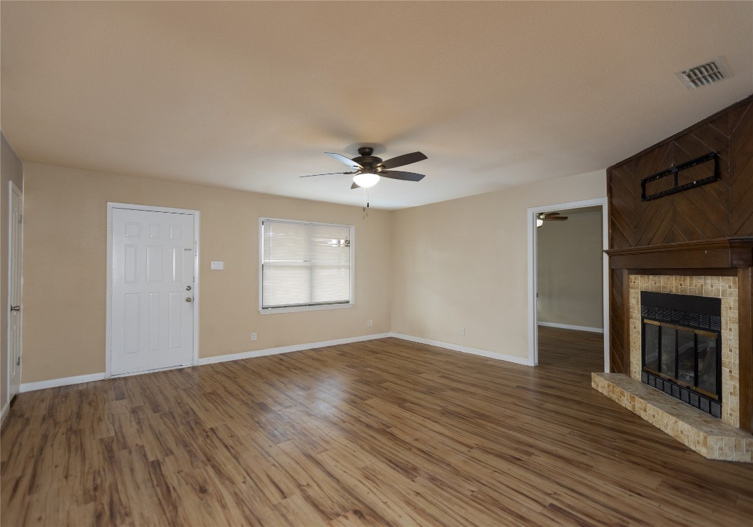 111 Branch View Drive Kyle, TX 78640 - Photo 6 of 27 a view of a livingroom with a ceiling fan fireplace and wooden floor