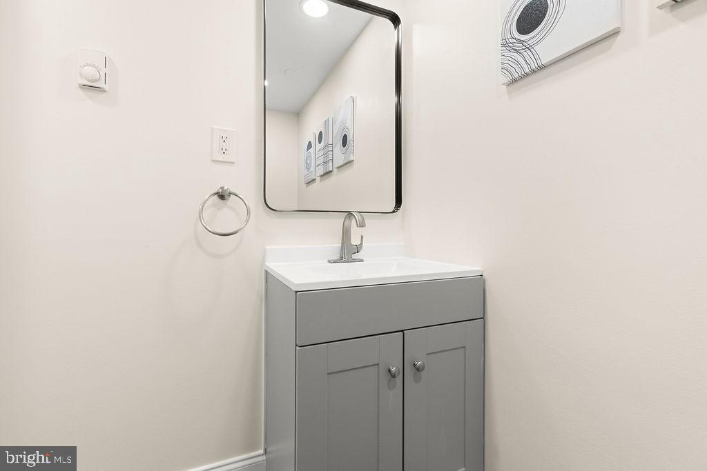 503 South Maple Court Sterling, VA 20164 - Photo 18 of 43 a bathroom with a sink and mirror
