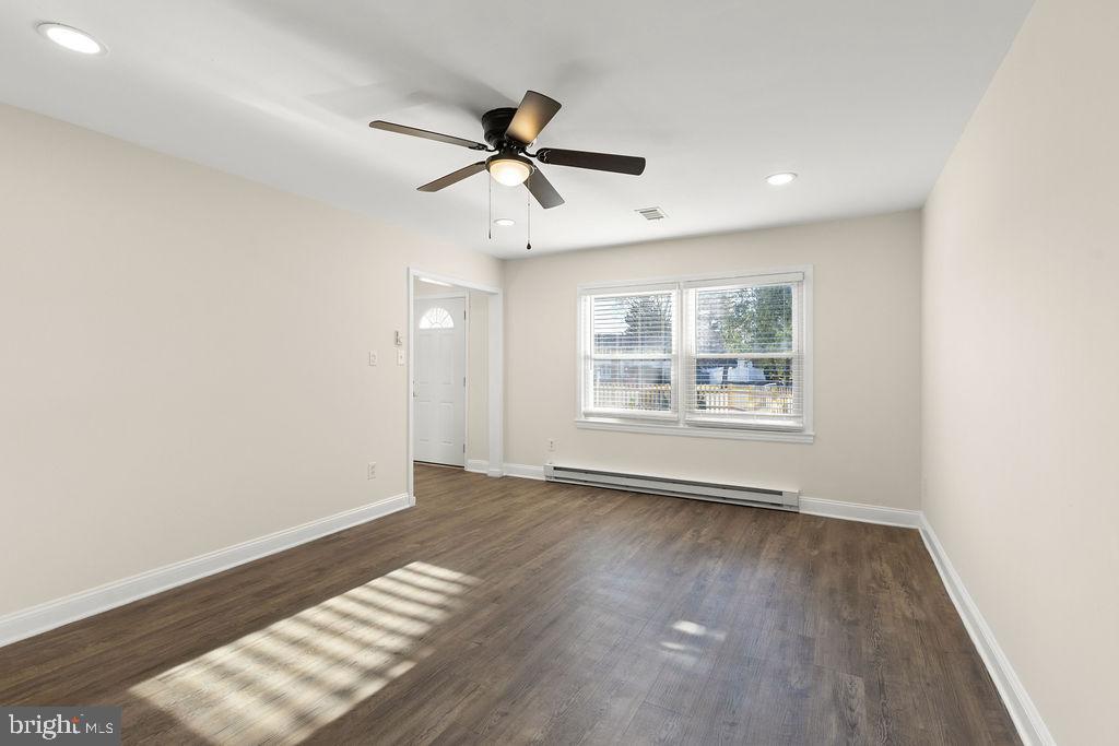 503 South Maple Court Sterling, VA 20164 - Photo 4 of 43 a view of an empty room with wooden floor and a window
