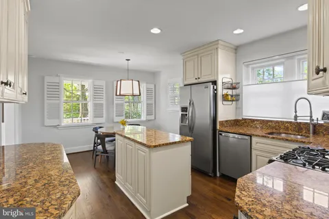 a view of a dining room with furniture a chandelier and wooden floor