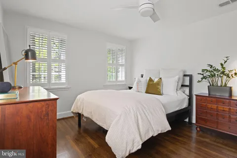 a bedroom with two beds and a window