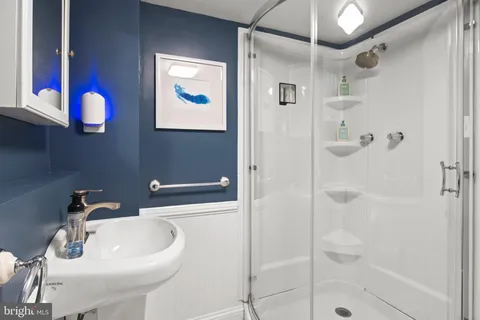 a view of backyard with a table and chairs with wooden fence and plants