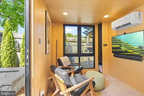 a work room with furniture and a flat screen tv