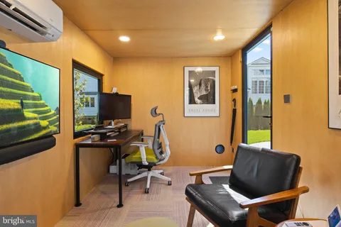 a view of a chair and table in backyard of the house