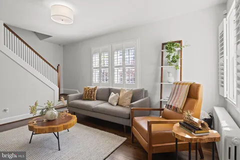 a kitchen with stainless steel appliances granite countertop a refrigerator a stove a sink a dining table and chairs