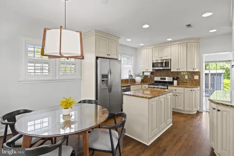 a kitchen with kitchen island granite countertop a stove sink and refrigerator
