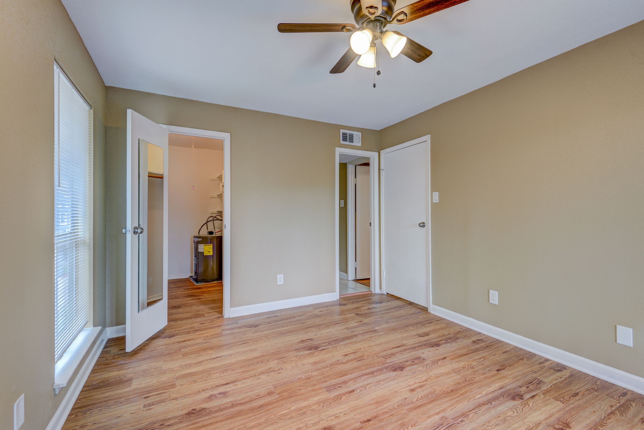18519 Egret Bay Boulevard, Unit 1704 Webster, TX 77058 - Photo 11 of 35 wooden floor in an empty room with a window