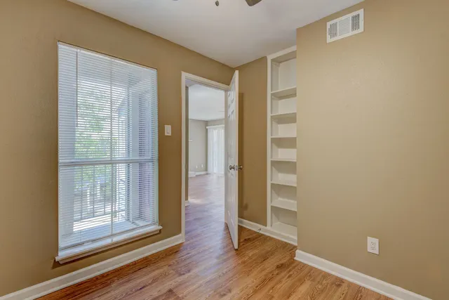 a view of wooden floor and windows in a room