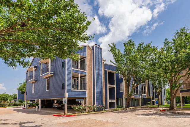 a front view of a building with trees