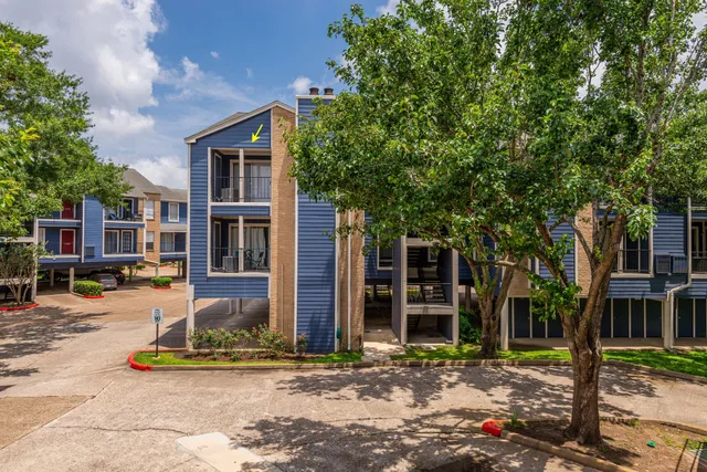 a front view of a house with a tree