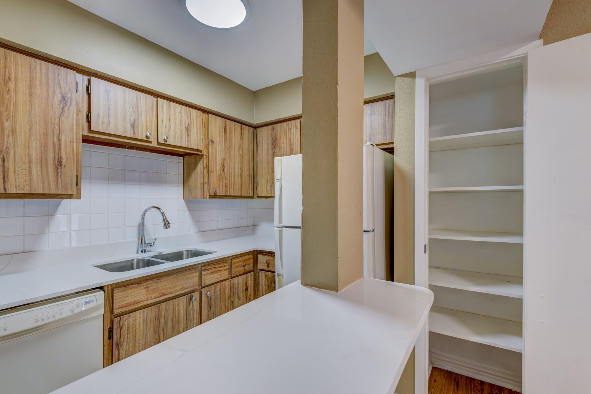 18519 Egret Bay Boulevard, Unit 1704 Webster, TX 77058 - Photo 8 of 35 a kitchen with a refrigerator and a sink
