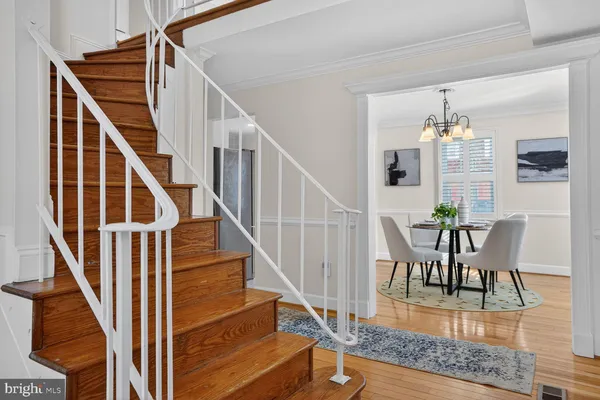 a living room with furniture a window and a potted plant