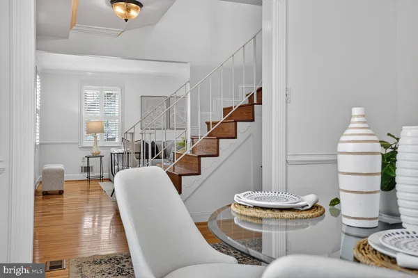 a view of staircase with railing and white walls