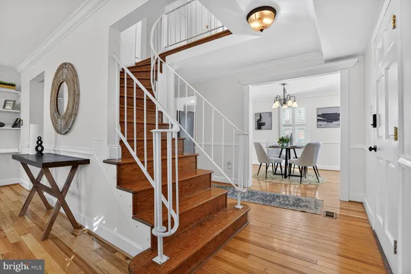 a living room with furniture a wooden floor and a large window