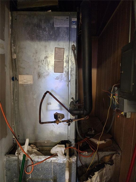 6958 Main Street Lithonia, GA 30058 - Photo 18 of 55 a room with water heater and wooden cabinets