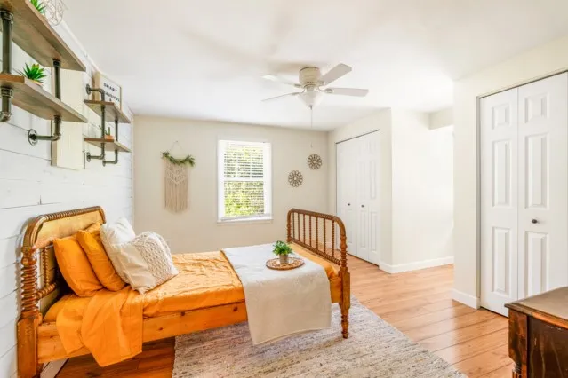 a bedroom with a bed and wooden floor