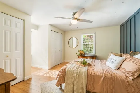 a bedroom with a bed and a window