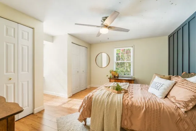 a bedroom with a bed and a window
