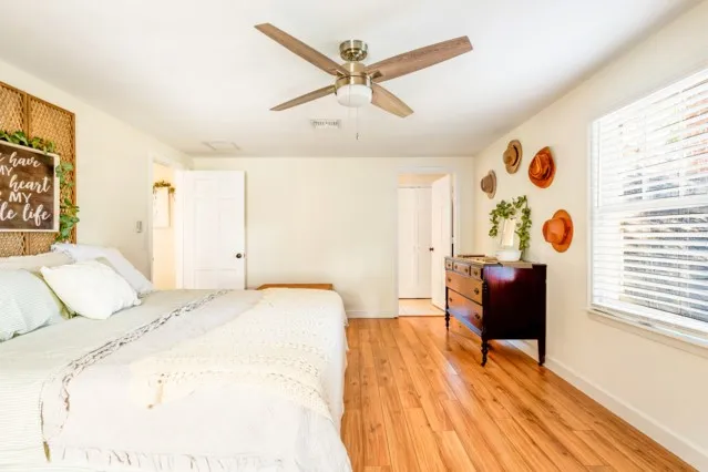 a spacious bedroom with a bed and a table in it