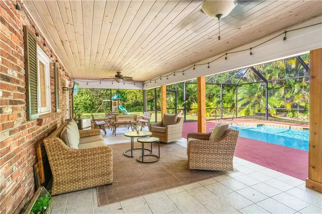 a living room with furniture and a floor to ceiling window