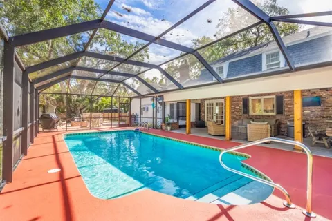 a swimming pool with large glass windows and painted walls