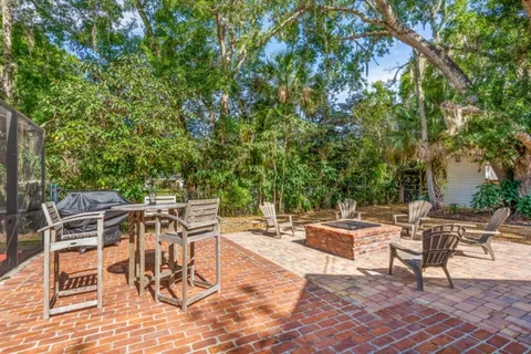 a view of a patio with a table and chairs and couches