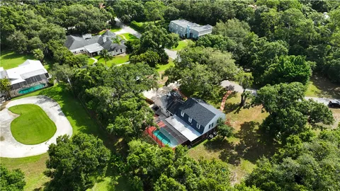 an aerial view of a house with a yard and garden