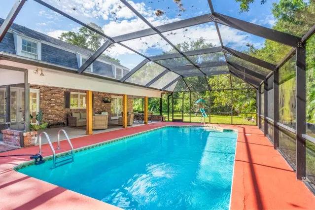 a view of swimming pool with a yard