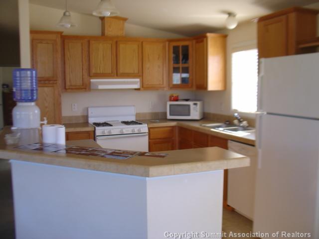 5220 Co 5 Road Fairplay, CO 80440 - Photo 7 of 18 a kitchen with stainless steel appliances granite countertop a sink a stove and a refrigerator