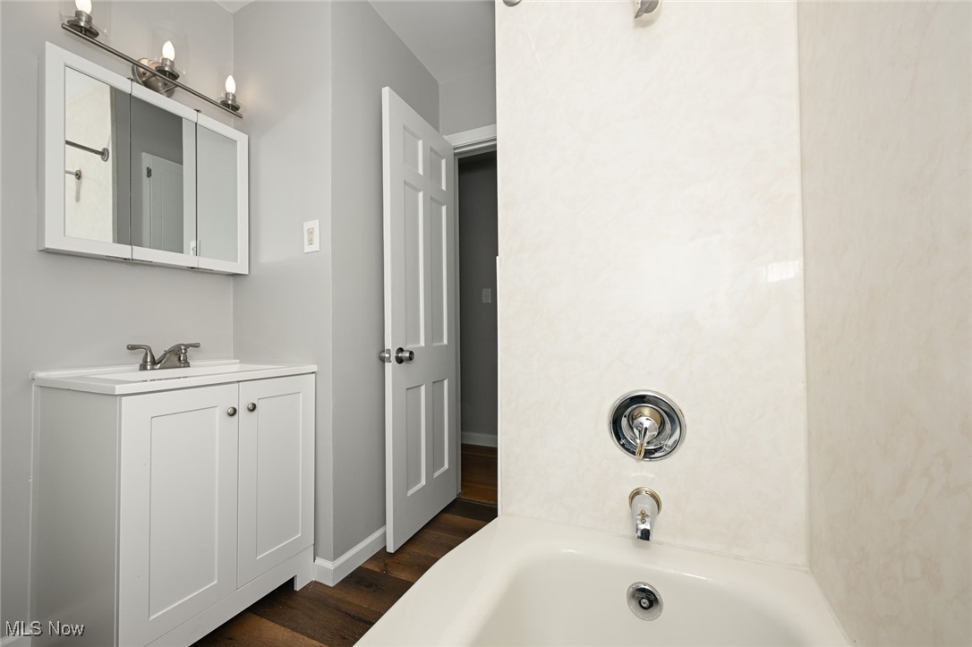 1571 Lander Road Cleveland, OH 44124 - Photo 9 of 39 Bathroom featuring vanity, bathtub / shower combination, and dark wood-style flooring