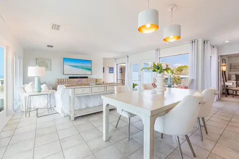 a dining room with furniture and a chandelier
