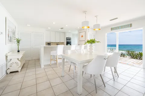 a large white kitchen with a table and chairs