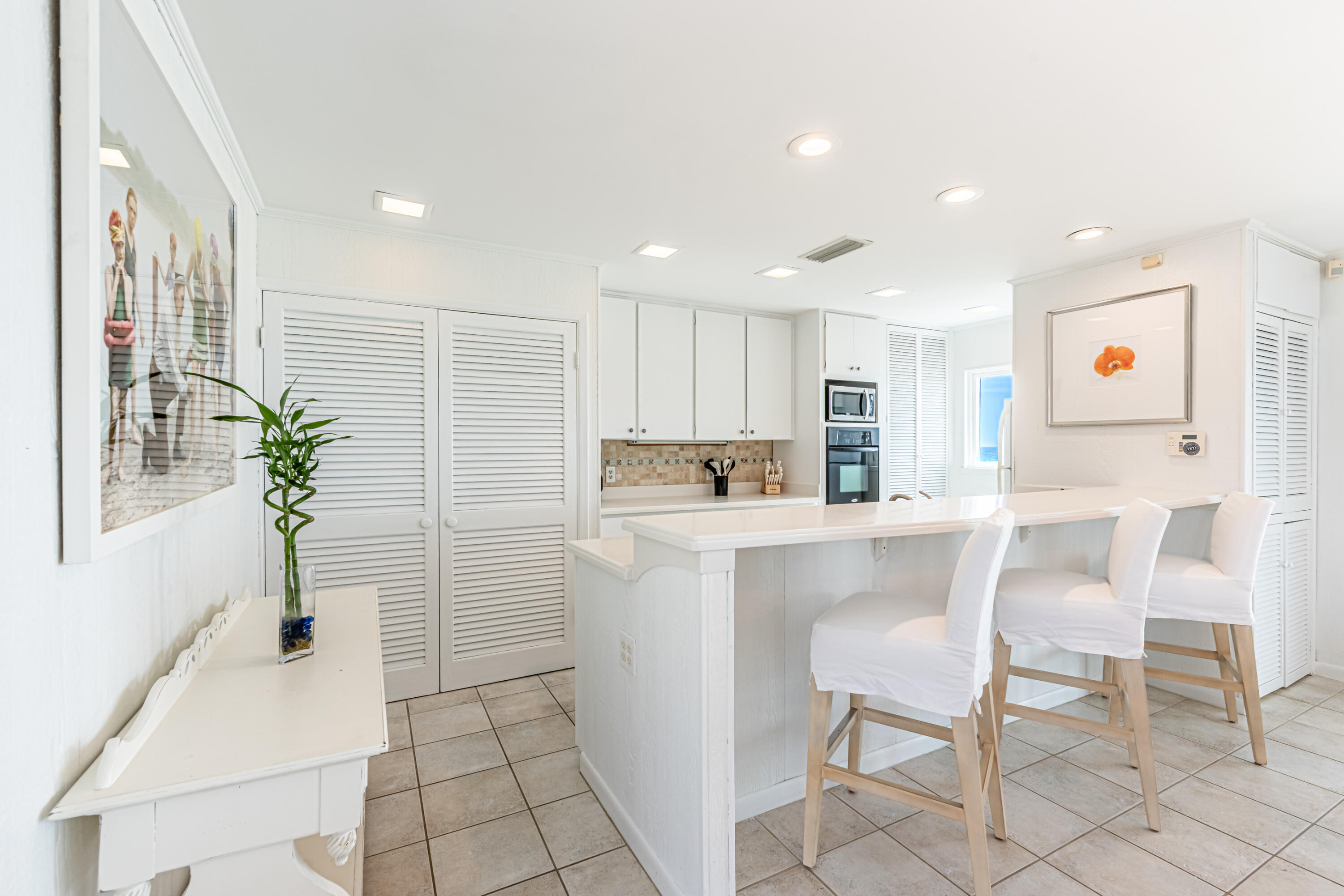 4731 West County Highway 30A Santa Rosa Beach, FL 32459 - Photo 14 of 44 a kitchen with a table and chairs