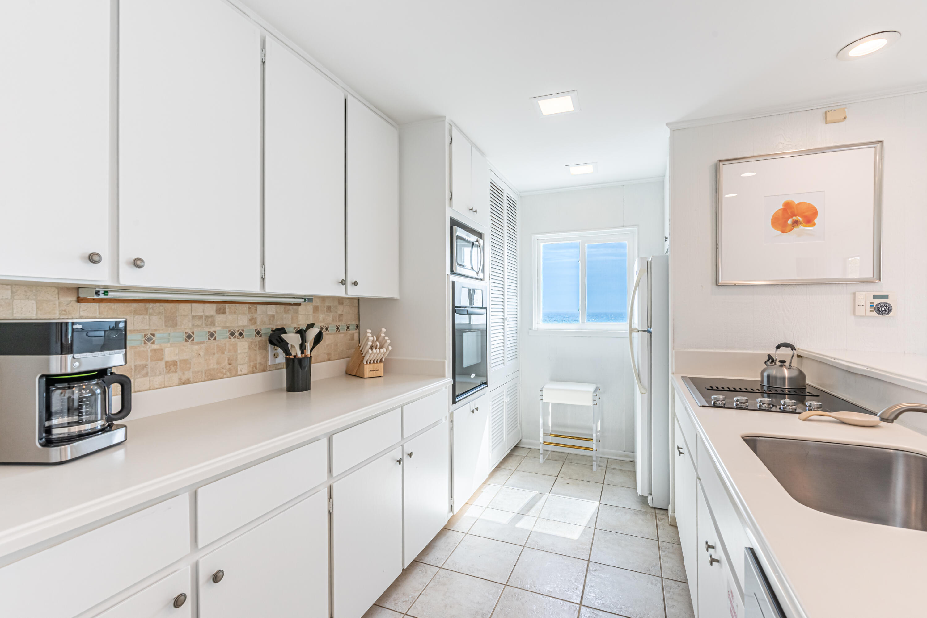 4731 West County Highway 30A Santa Rosa Beach, FL 32459 - Photo 16 of 44 a kitchen with a sink and cabinets