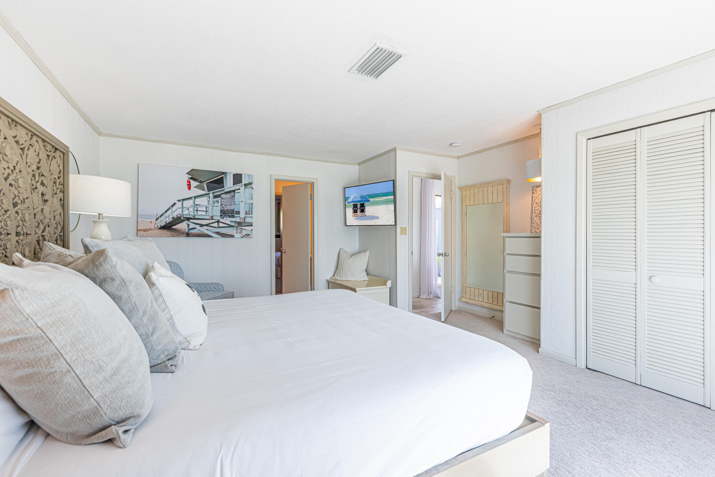 4731 West County Highway 30A Santa Rosa Beach, FL 32459 - Photo 26 of 44 a spacious bedroom with a bed and walk in closet