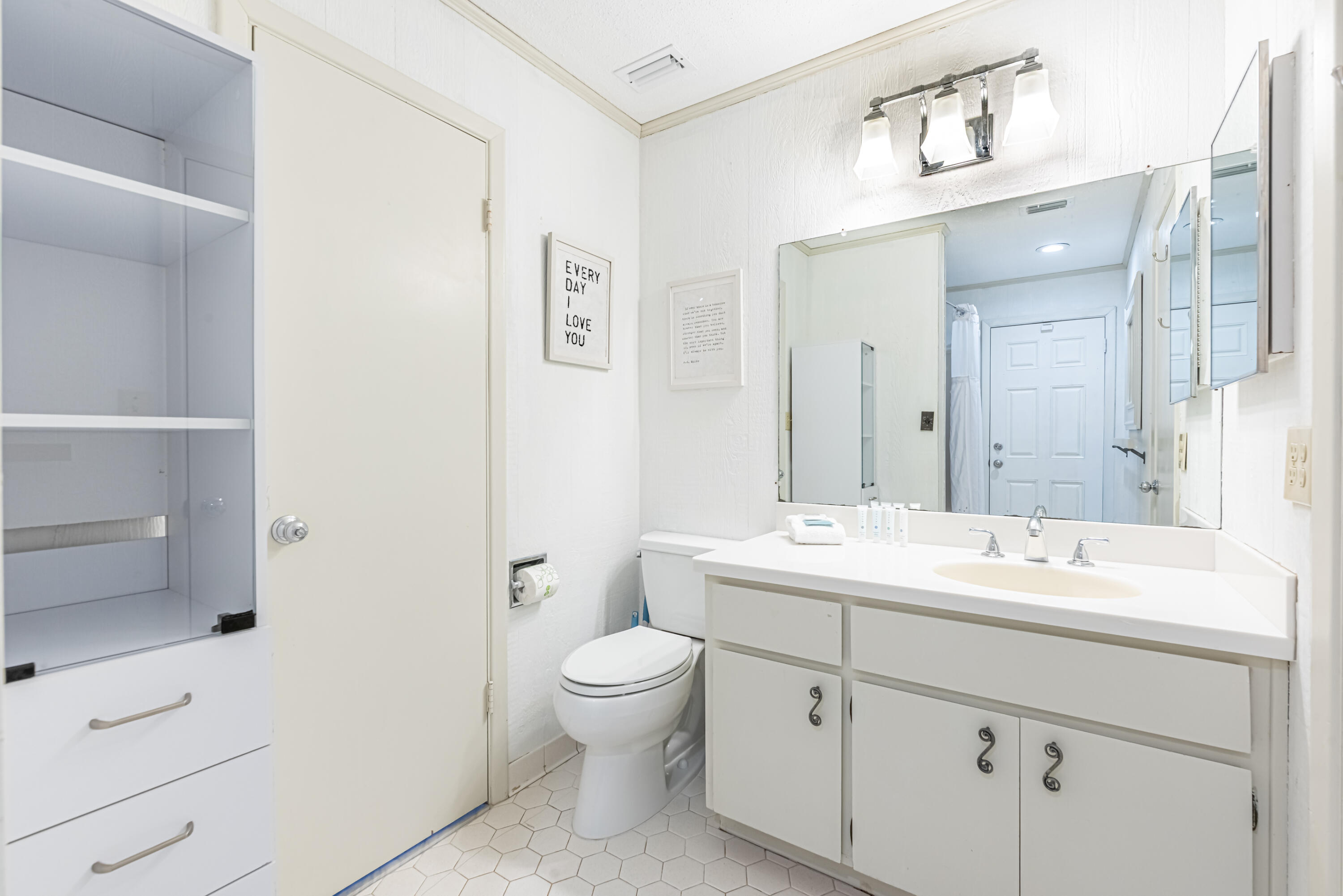 4731 West County Highway 30A Santa Rosa Beach, FL 32459 - Photo 27 of 44 a bathroom with a toilet a sink and mirror