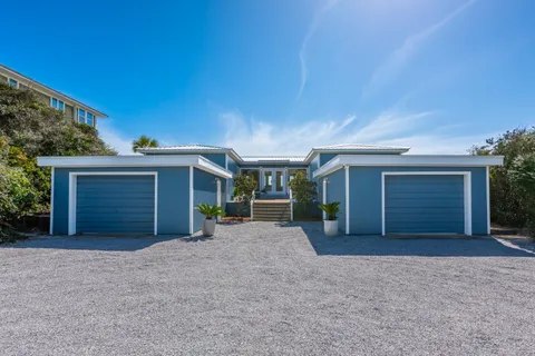 a view of a house with a yard and garage