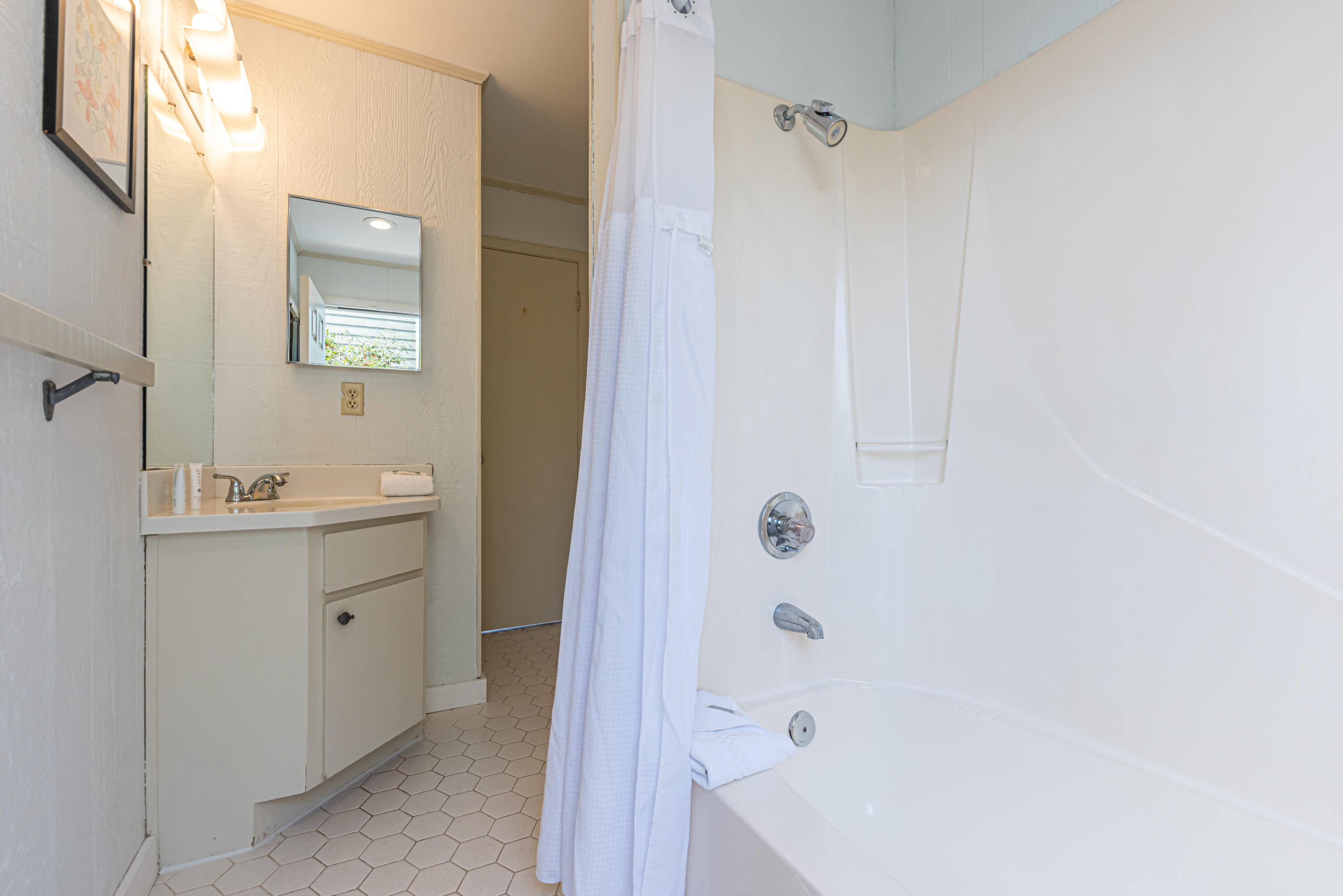 4731 West County Highway 30A Santa Rosa Beach, FL 32459 - Photo 33 of 44 a bathroom with a sink a mirror and a shower