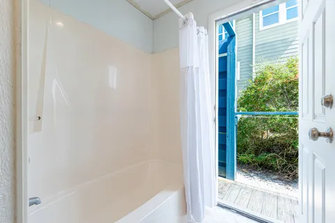 a spacious bedroom with a bed a mirror and a window