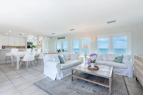 a living room with furniture dining table and a view of kitchen