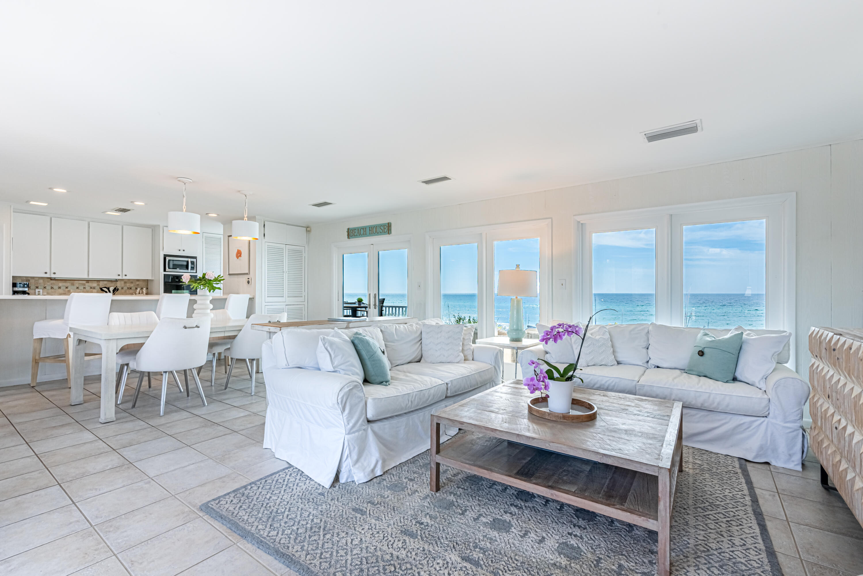 4731 West County Highway 30A Santa Rosa Beach, FL 32459 - Photo 5 of 44 a living room with furniture dining table and a view of kitchen