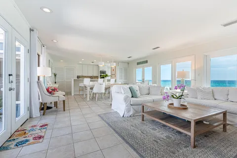 a living room with furniture and a dining table with kitchen view